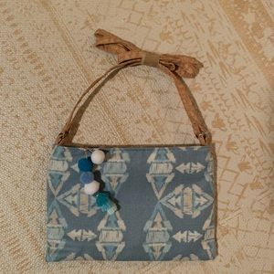 Small terra bag with Pom Pom zipper opening and long crossbody strap